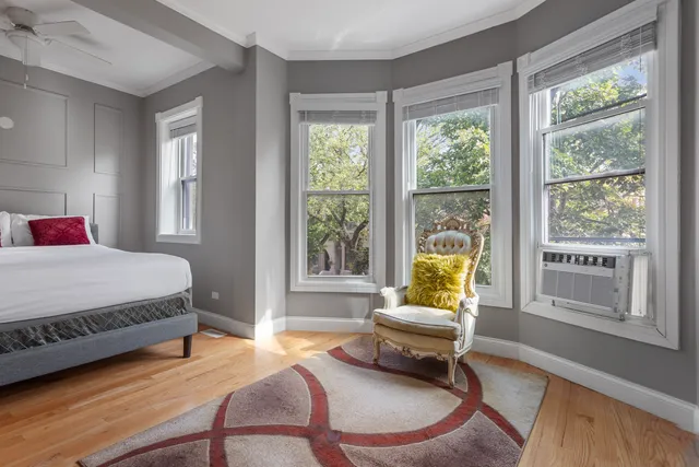 a living room with a bed and a couch next to a window