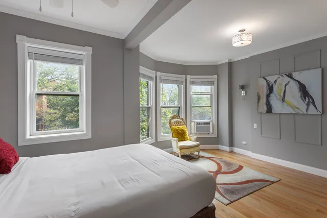 a bedroom with a bed and glass windows