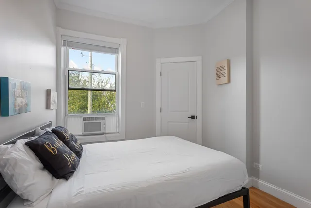 a bedroom with a bed and a window
