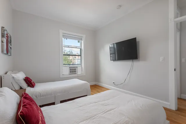 a bedroom with a bed and a flat screen tv