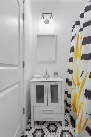 a bathroom with a sink and a mirror
