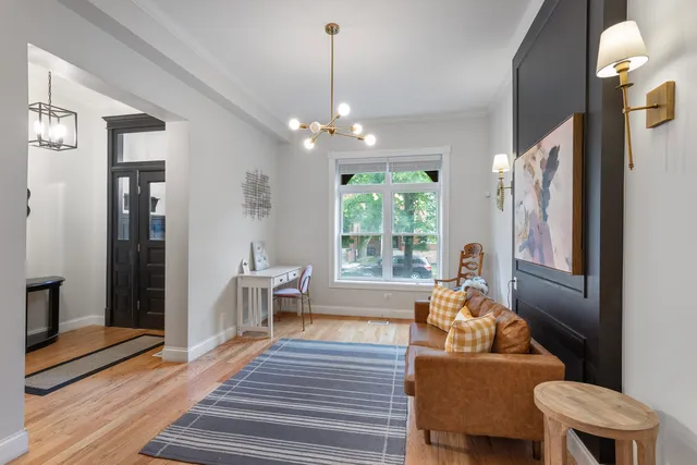 a living room with furniture and a chandelier