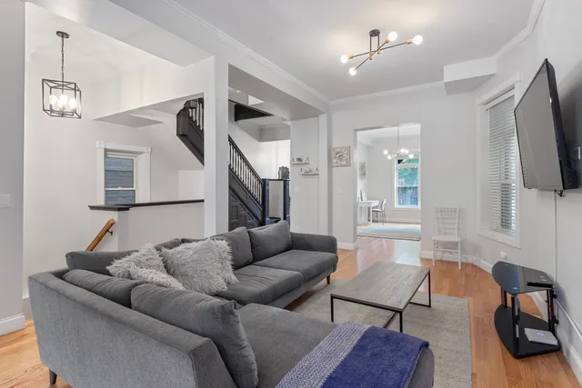 a living room with furniture ceiling fan and a wooden floor