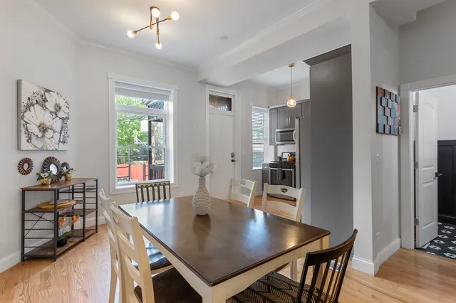 a view of a dining room with furniture and a chandelier