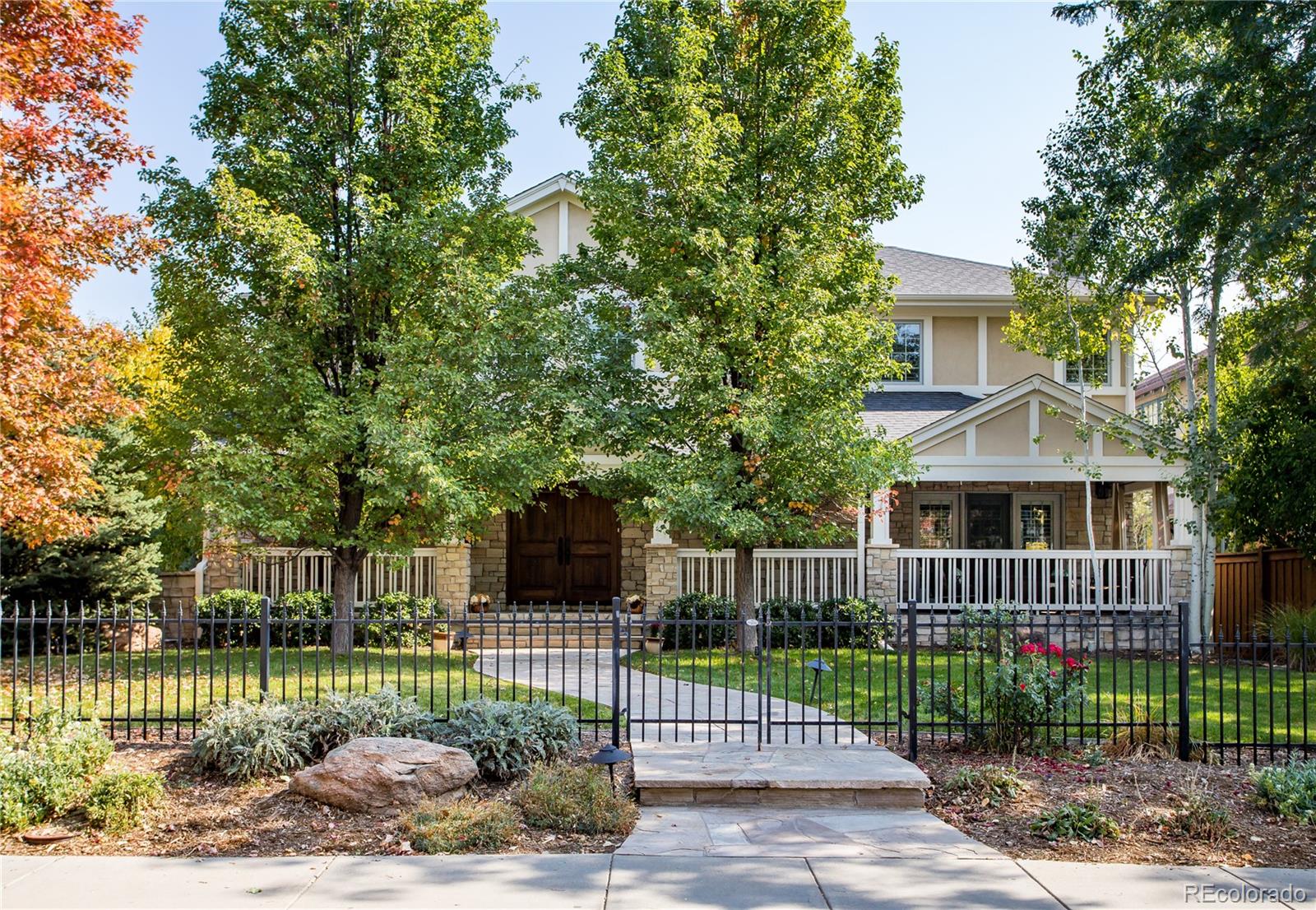 a front view of a house with a garden and plants