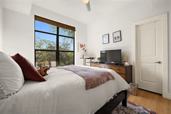 a bedroom with a bed and a window