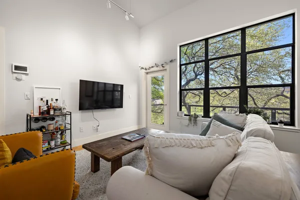 a living room with furniture and a large window