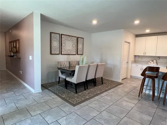 a living room with furniture a flat screen tv and a window