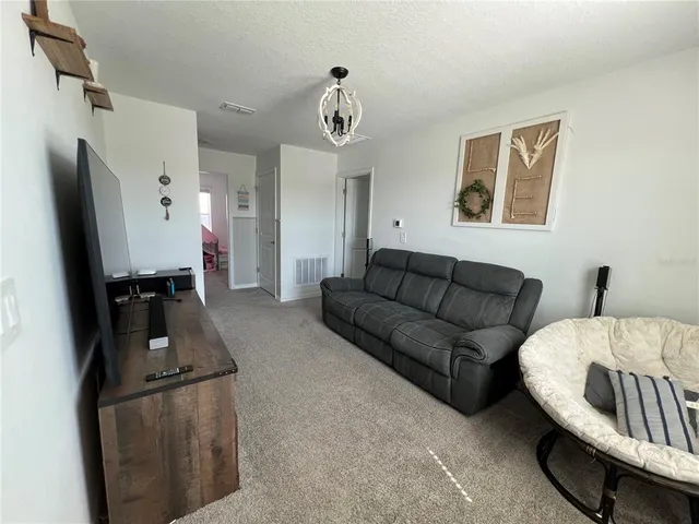 a bedroom with a bed and lamp