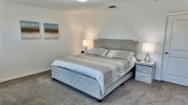 a bedroom with a bed and a dresser