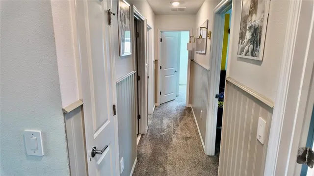 a bedroom with a bed and a white wall