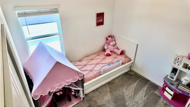 a view of a livingroom with furniture and a window