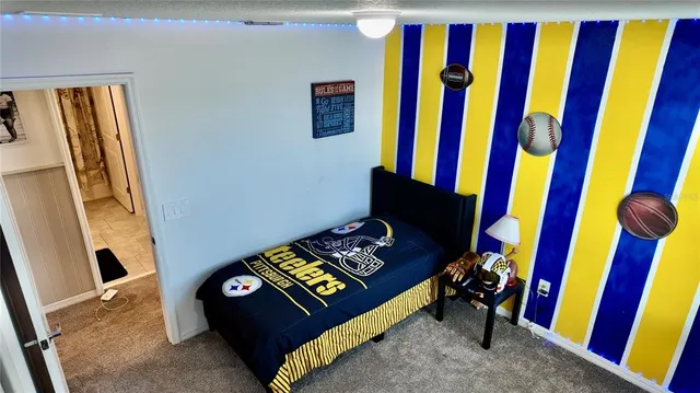 a living room with furniture with wall paintings on the wall