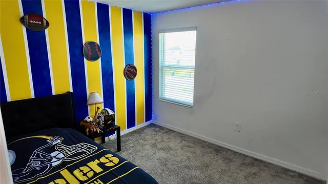 a view of a roof deck with table and chairs with wooden floor and fence