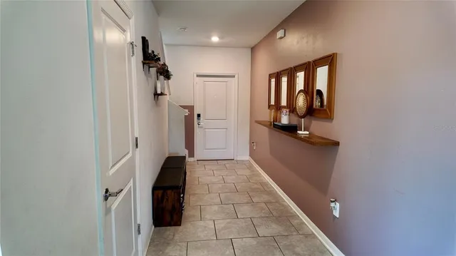 a living room with furniture kitchen view and a potted plant
