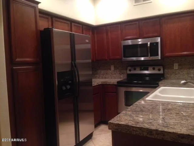 a kitchen with a refrigerator and a sink