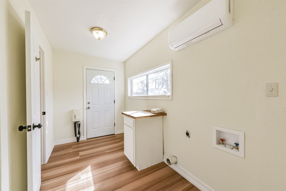 2619 Bellview Street La Marque, TX 77568 - Photo 24 of 46 a view of a hallway with wooden floor and white cabinet
