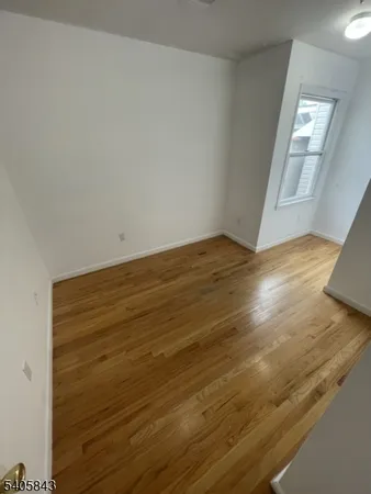 a view of an empty room and wooden floor