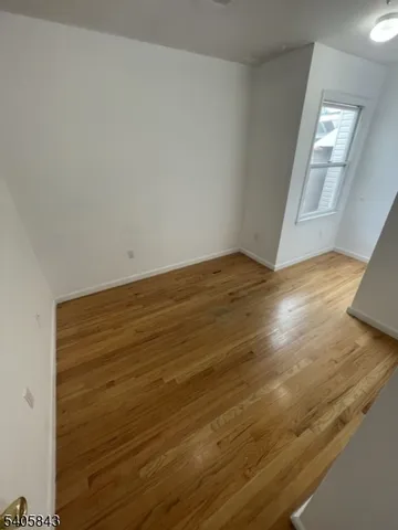 a view of an empty room and wooden floor