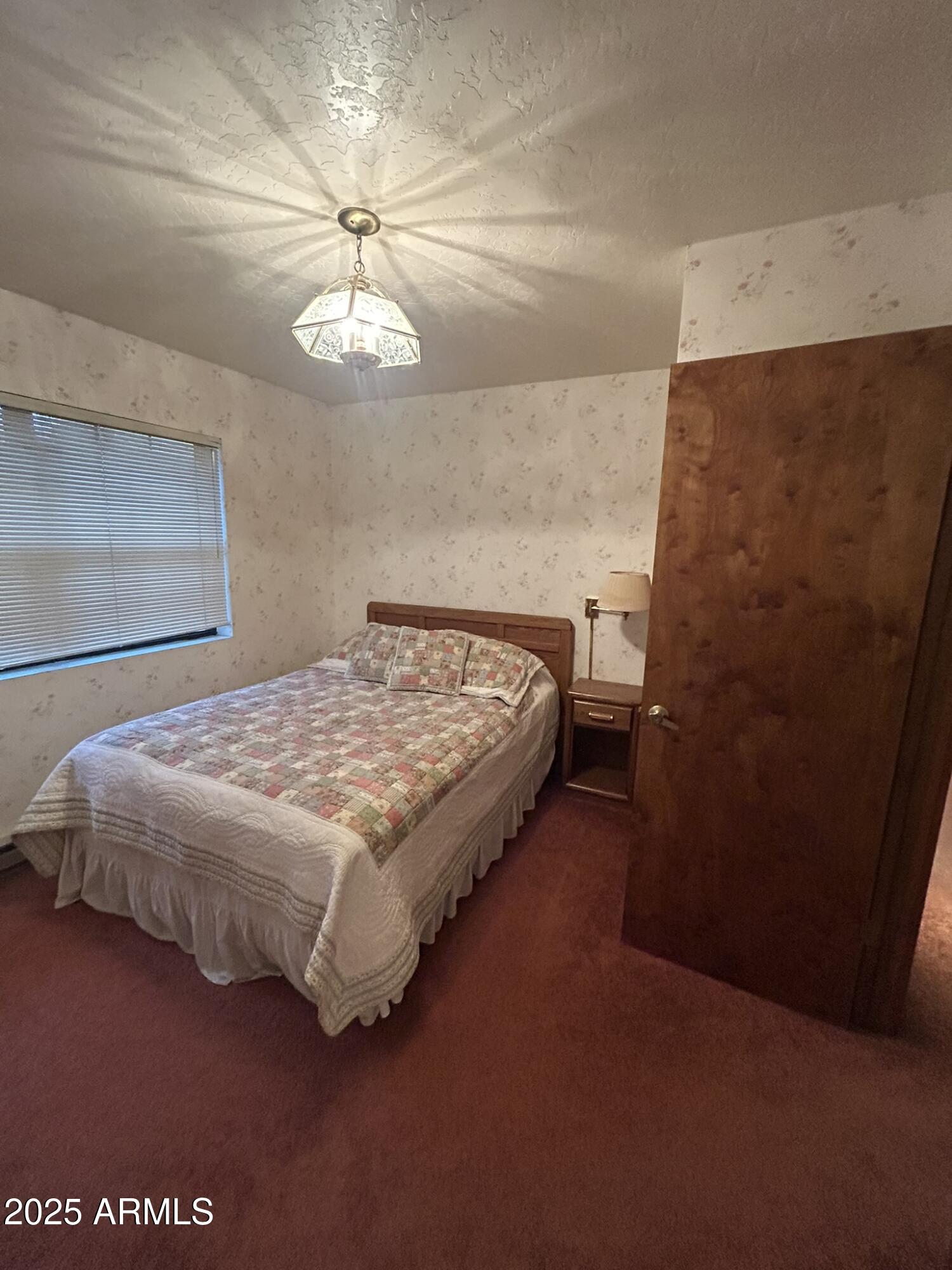3 County Road Greer, AZ 85927 - Photo 26 of 65 a bedroom with a bed and a ceiling fan