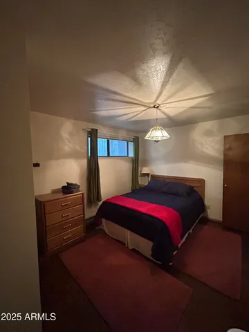 a living room with furniture fireplace and a large window