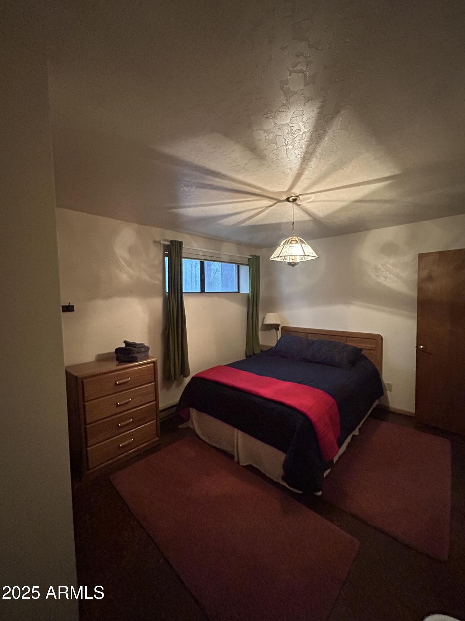3 County Road Greer, AZ 85927 - Photo 44 of 65 a bedroom with a bed and a dresser