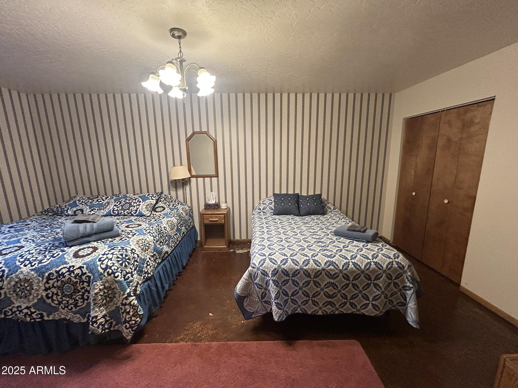 3 County Road Greer, AZ 85927 - Photo 48 of 65 a bedroom with a bed mirror and window
