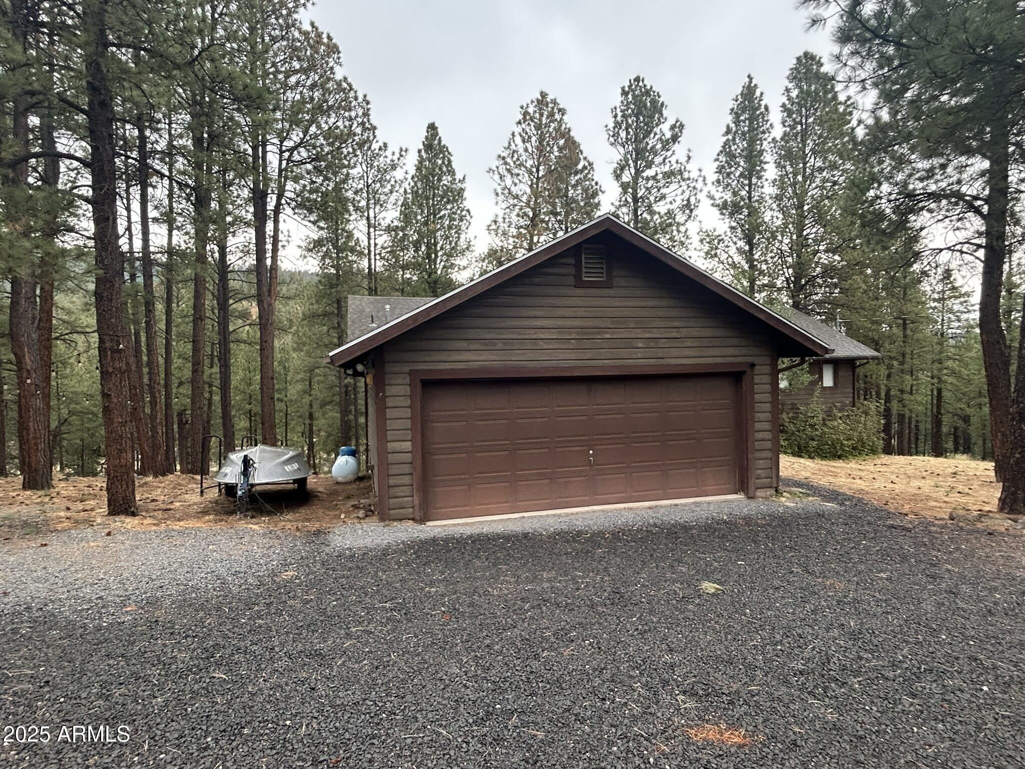 3 County Road Greer, AZ 85927 - Photo 8 of 65 a view of a house with a yard and garage