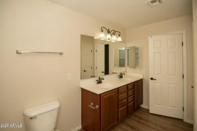 a bathroom with a tub a sink and a large mirror