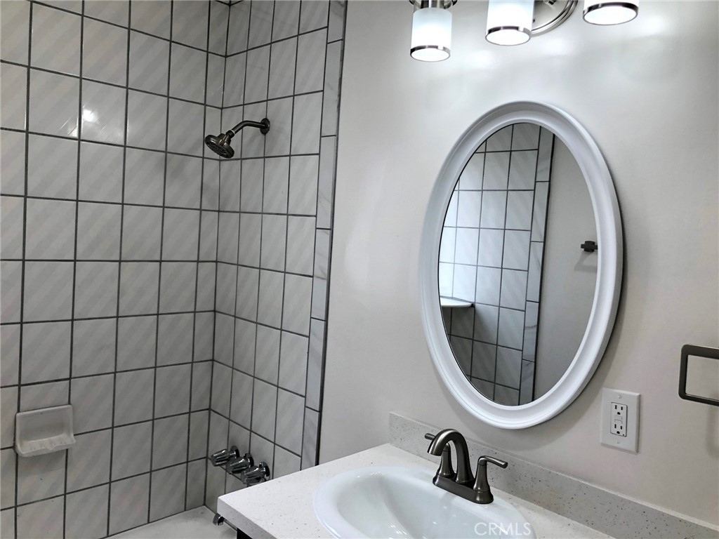 307 Cherry Avenue, Unit 5 Long Beach, CA 90802 - Photo 17 of 20 a bathroom with a sink a toilet and a mirror