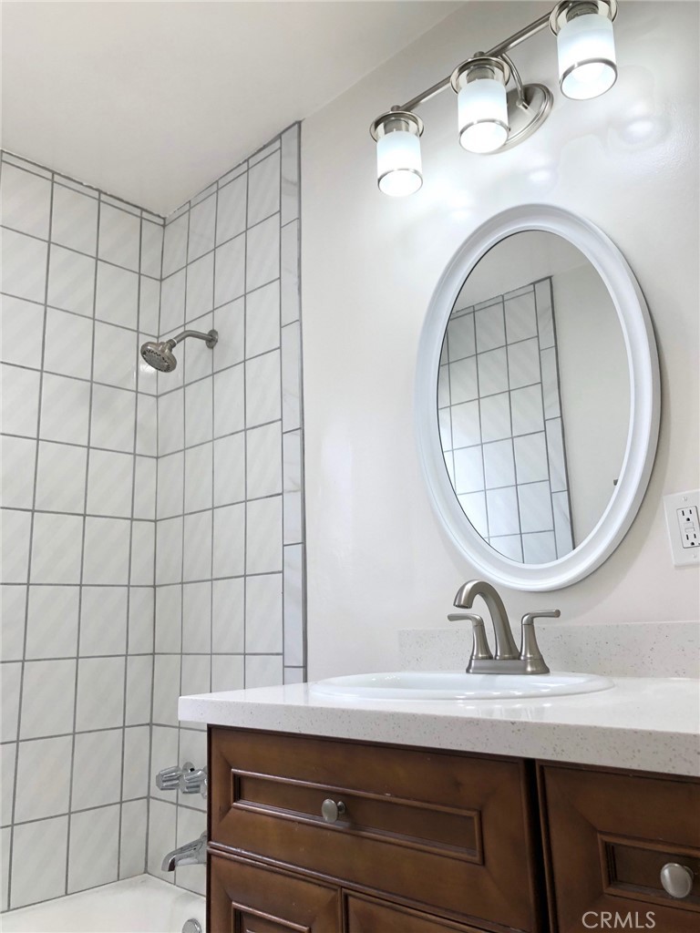 307 Cherry Avenue, Unit 5 Long Beach, CA 90802 - Photo 18 of 20 a bathroom with a sink a mirror and vanity