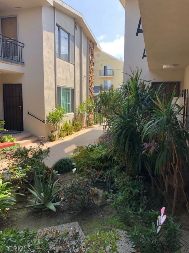 307 Cherry Avenue, Unit 5 Long Beach, CA 90802 - Photo 3 of 20 a view of a house with a yard and plants