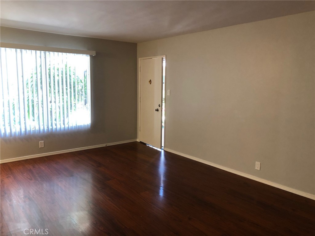 307 Cherry Avenue, Unit 5 Long Beach, CA 90802 - Photo 5 of 20 an empty room with wooden floor and windows