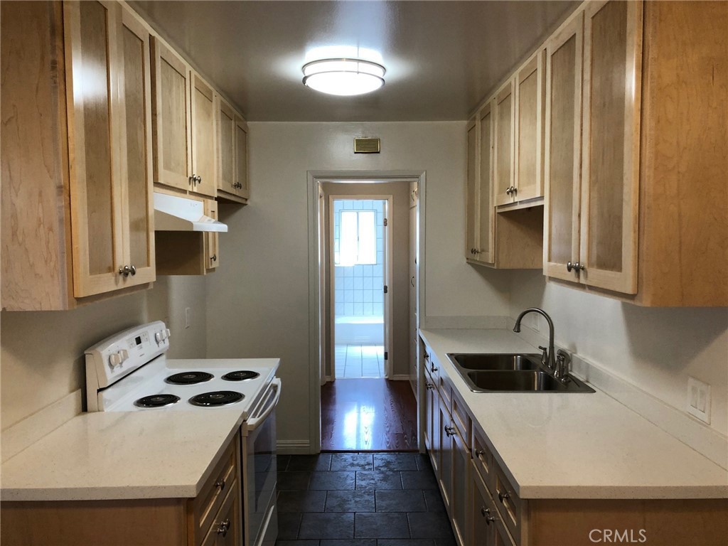 307 Cherry Avenue, Unit 5 Long Beach, CA 90802 - Photo 8 of 20 a kitchen with stainless steel appliances a sink stove and cabinets