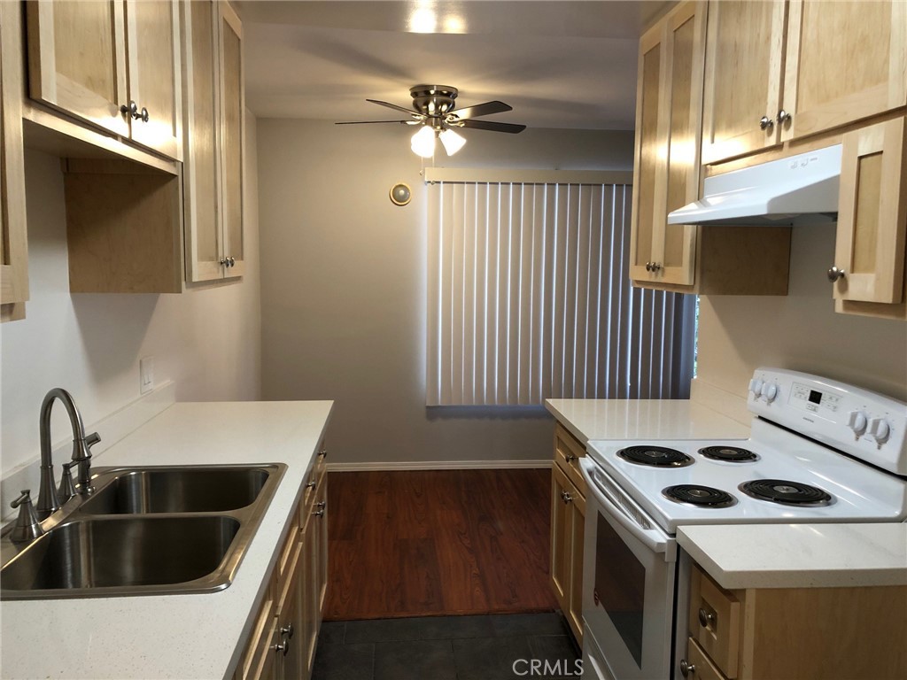 307 Cherry Avenue, Unit 5 Long Beach, CA 90802 - Photo 9 of 20 a kitchen that has a sink a stove and a window