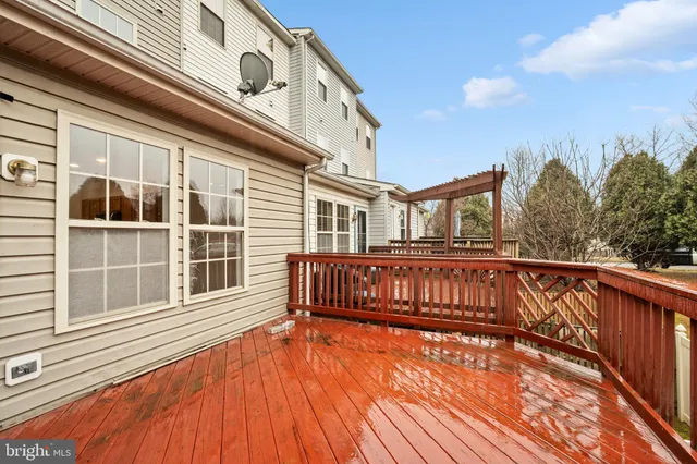 a view of a house with a wooden deck