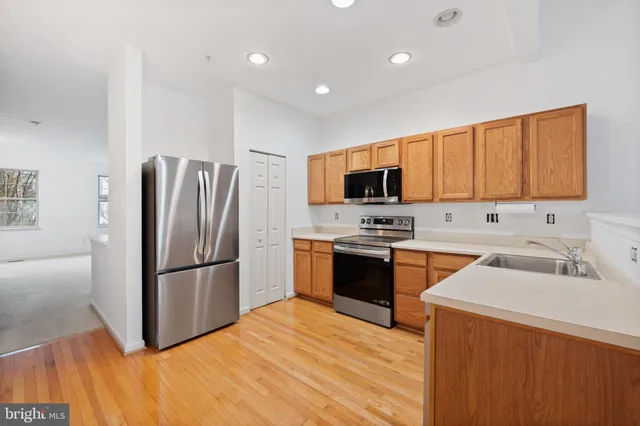 a kitchen with a refrigerator sink and microwave