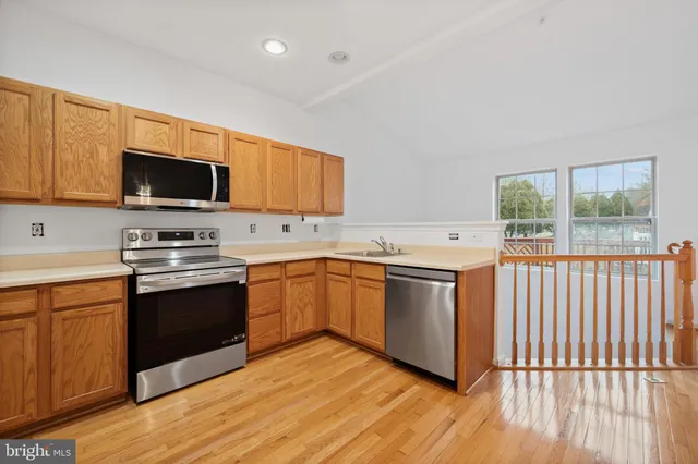 a kitchen with granite countertop a stove top oven sink and cabinets