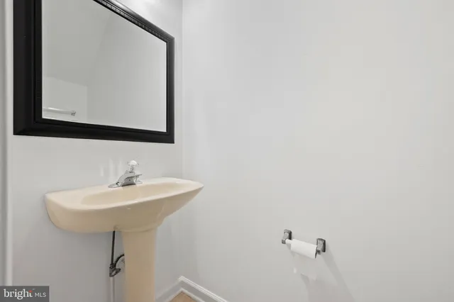 a bathroom with a sink a mirror and vanity