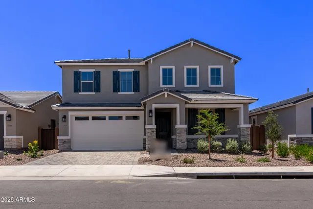a front view of a house with garage