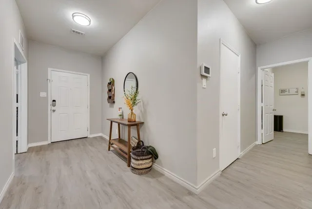 a view of a room with wooden floor gym equipment