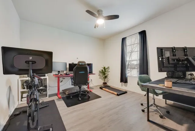a room with gym equipment and a large window