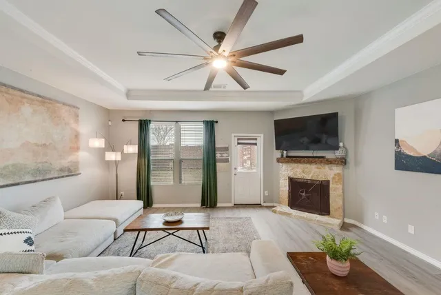 a living room with furniture a fireplace and a flat screen tv