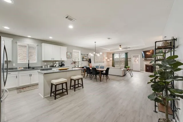 a kitchen with white cabinets sink and stainless steel appliances