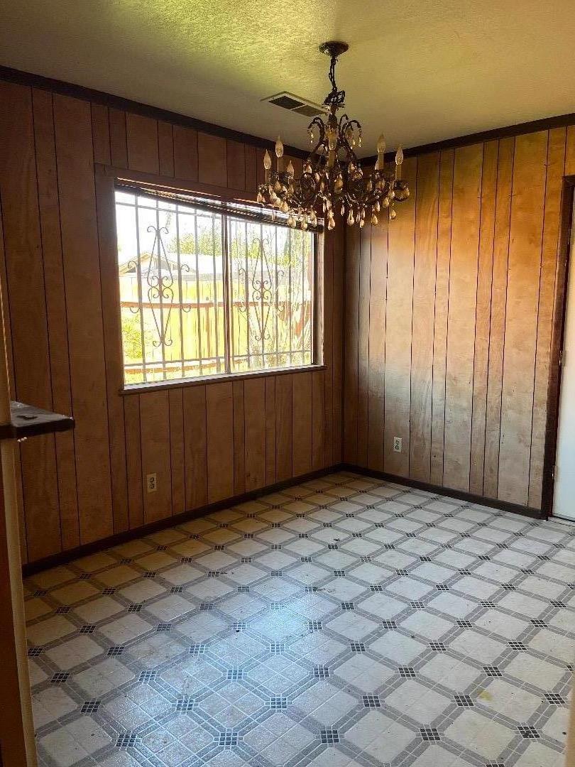 306 Maya Circle Soledad, CA 93960 - Photo 6 of 16 an empty room with windows and chandelier