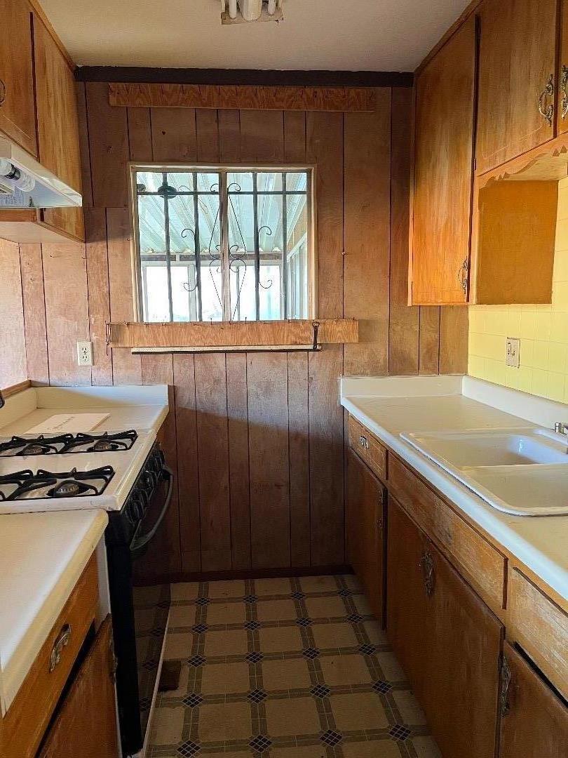 306 Maya Circle Soledad, CA 93960 - Photo 7 of 16 a kitchen with a sink a stove cabinets and a window
