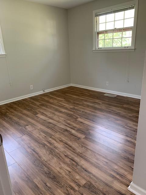 413 Cedarcliff Road Antioch, TN 37013 - Photo 5 of 12 an empty room with wooden floor and windows