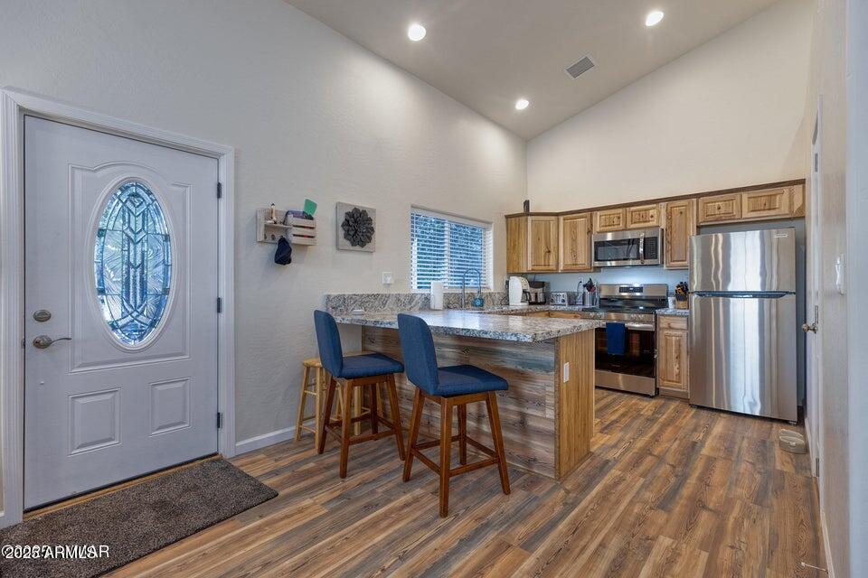 2145 Cottontail Road Overgaard, AZ 85933 - Photo 11 of 22 a kitchen with a table chairs refrigerator and cabinets