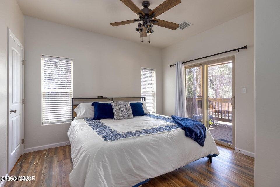 2145 Cottontail Road Overgaard, AZ 85933 - Photo 15 of 22 a bedroom with a large bed and a chandelier