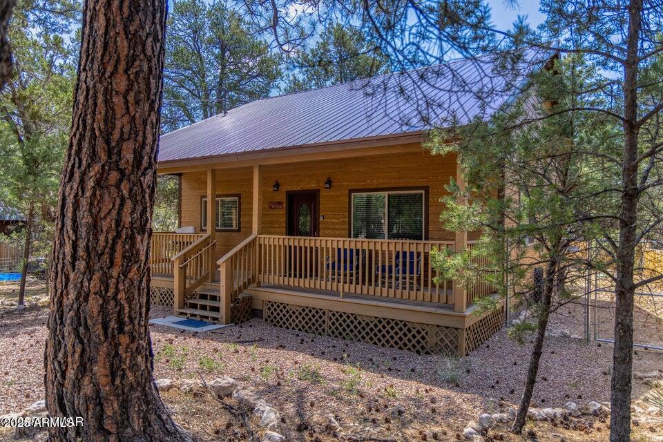 2145 Cottontail Road Overgaard, AZ 85933 - Photo 2 of 22 a view of a house with a small yard and a large tree